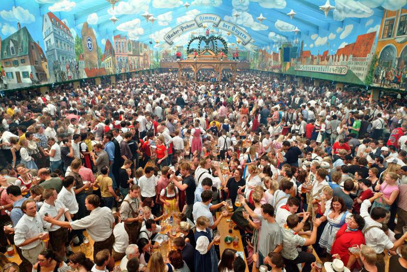 During Oktoberfest in Germany, visitors celebrate food and beverage in a vibrant atmosphere During Oktoberfest in Germany, visitors celebrate food and beverage in a vibrant atmosphere