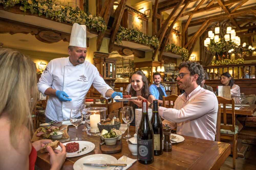 Traditional food experience in Warsaw with a table, wine and a cozy ambiance.
