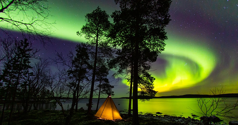 Come to Finland and experience the Northern Lights over a lake