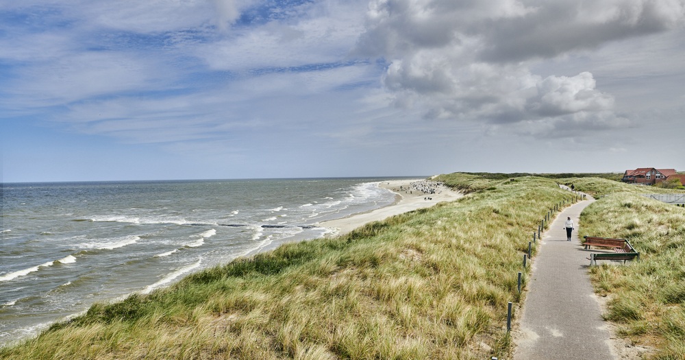 Pathway along the grassy dunes leading to the North Sea beach on the island of Sylt, Germany.