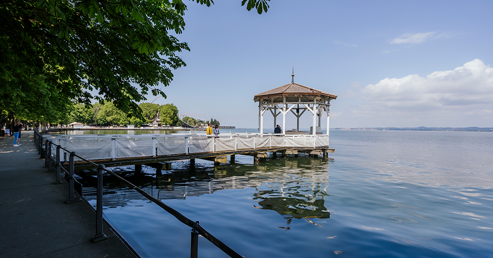 Scenic promenade along Lake Constance with a lakeside pavilion.