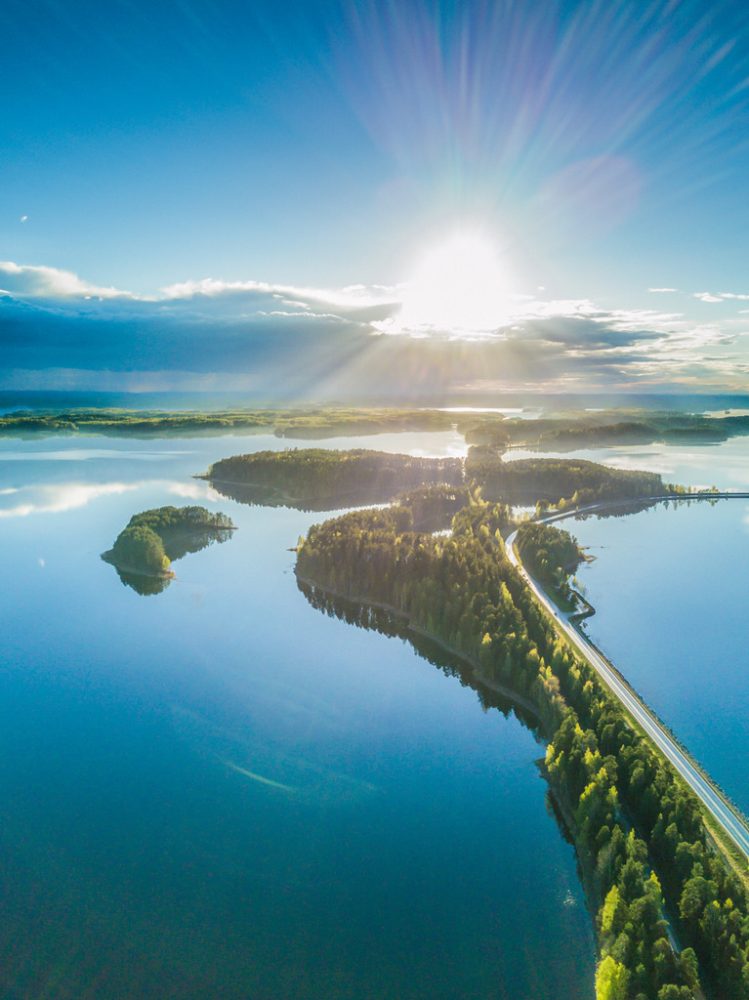 Aerial view of the scenic Punkaharju ridge and surrounding lakes in Finland under bright sunlight.