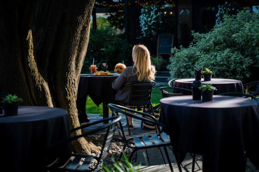 Two women sited at summer terraces in Riga.