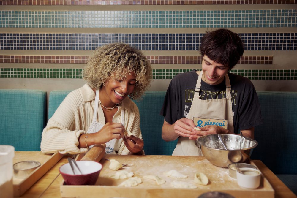 Traveler making pierogi during a cooking class in Warsaw, experiencing Polish traditions.